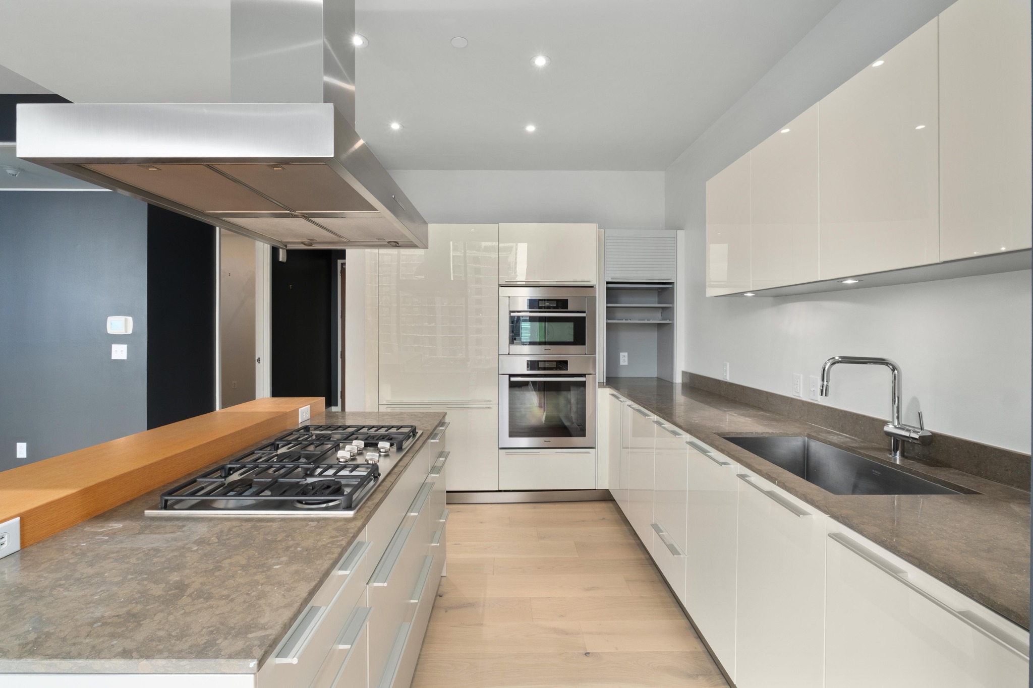 210 Lavaca Street, Unit 1810 Austin, TX 78701 - Photo 6 of 28 Kitchen featuring island exhaust hood, white cabinets, modern cabinets, stainless steel appliances, and recessed lighting