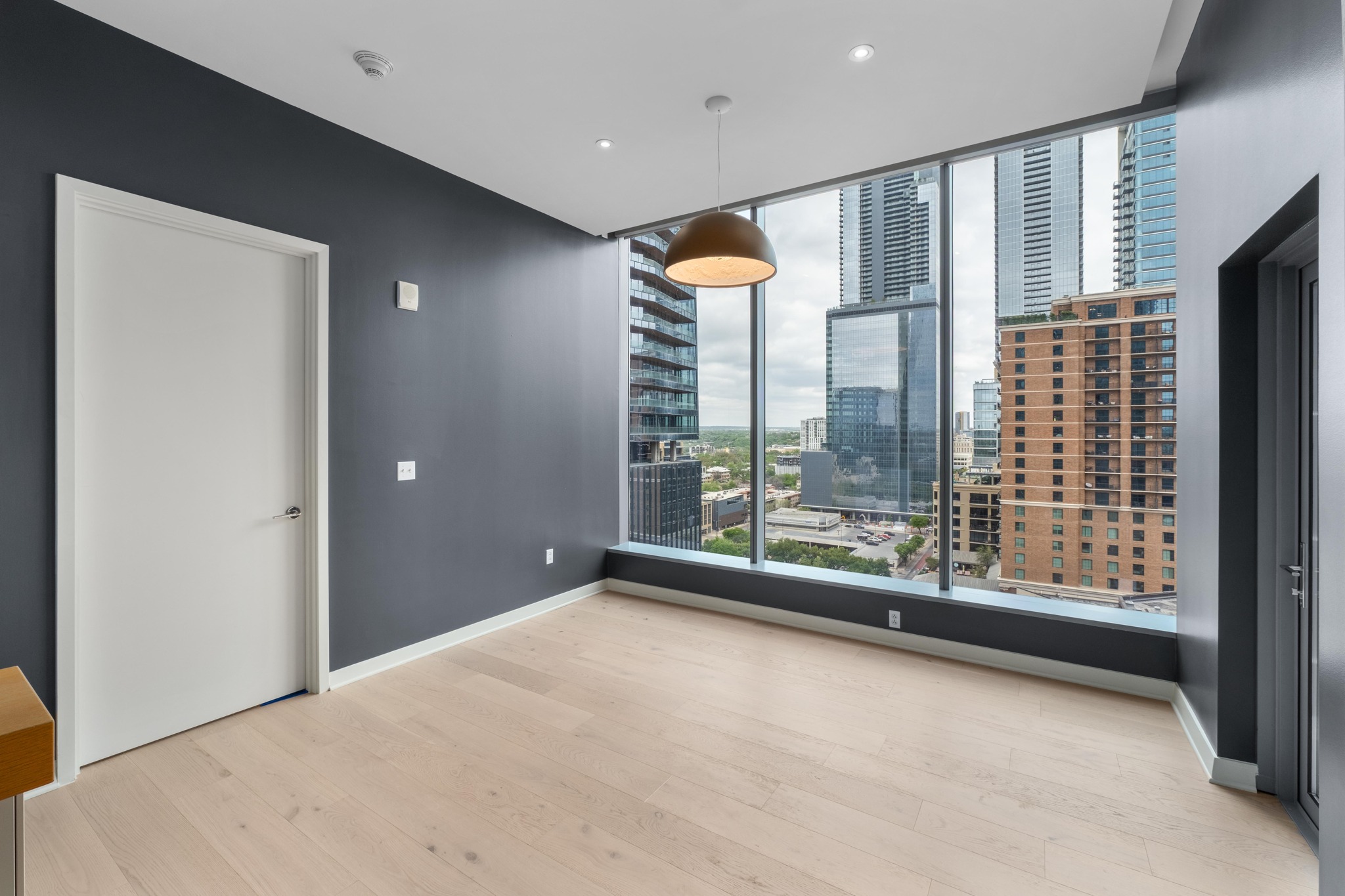 210 Lavaca Street, Unit 1810 Austin, TX 78701 - Photo 8 of 28 Unfurnished room featuring a city view, light wood finished floors, and recessed lighting