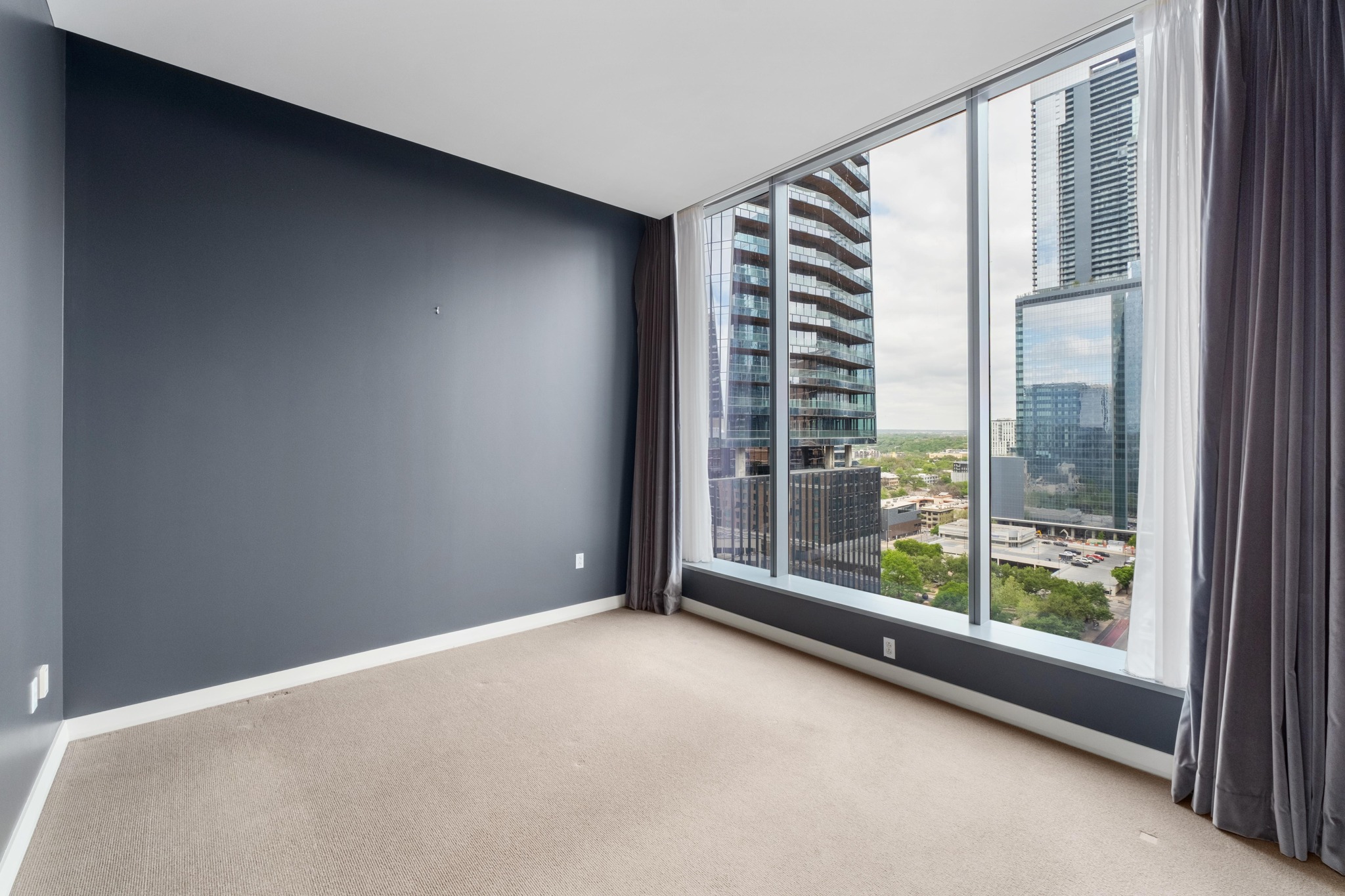 210 Lavaca Street, Unit 1810 Austin, TX 78701 - Photo 10 of 28 Spare room featuring a view of city and light colored carpet