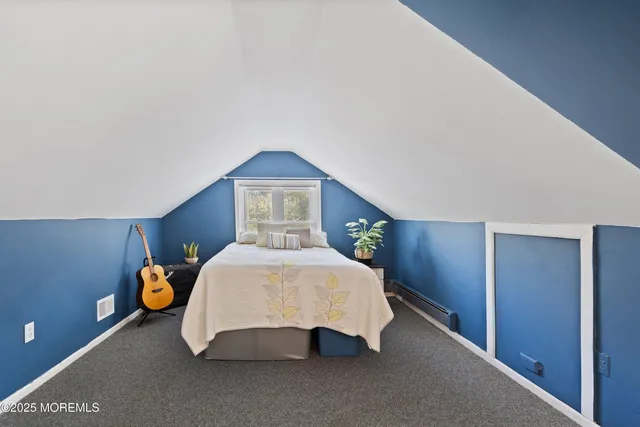 a bedroom with a bed and lamp