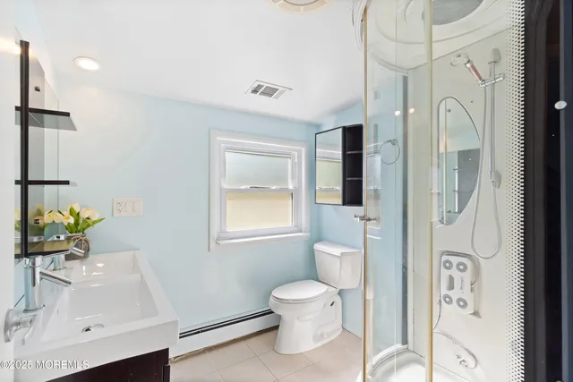 a bathroom with a toilet sink and shower