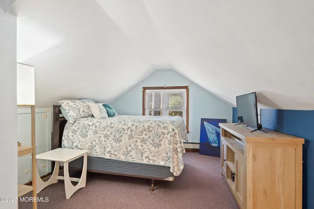 a bedroom with a bed and a chair