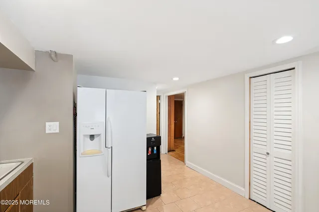 a view of hallway with a closet and a large window