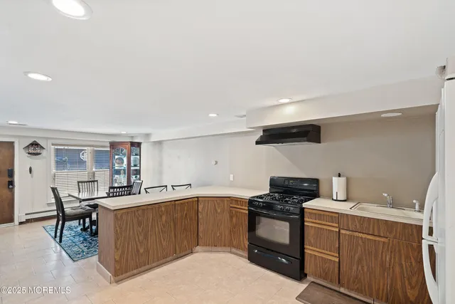 a kitchen with a sink and wooden cabinets