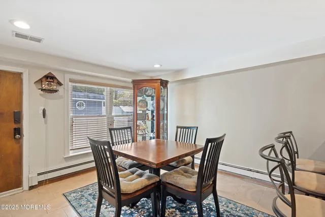 a view of a dining room with furniture and a window