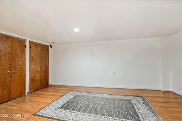 a view of room with window and wooden floor