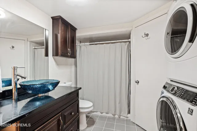 a bathroom with a toilet a sink and a mirror