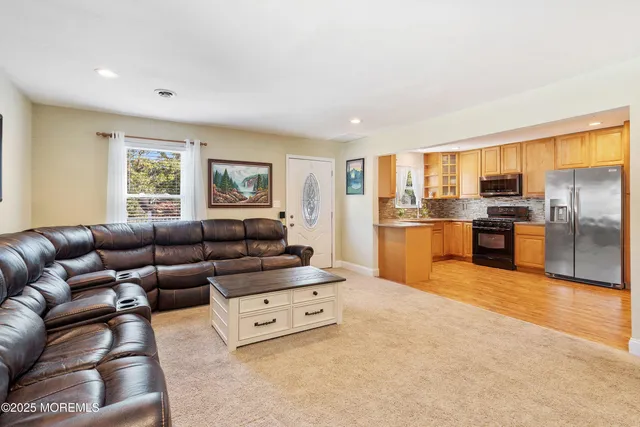 a living room with furniture and kitchen view