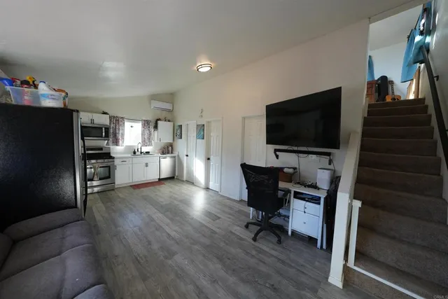 a view of a livingroom with furniture and a flat screen tv