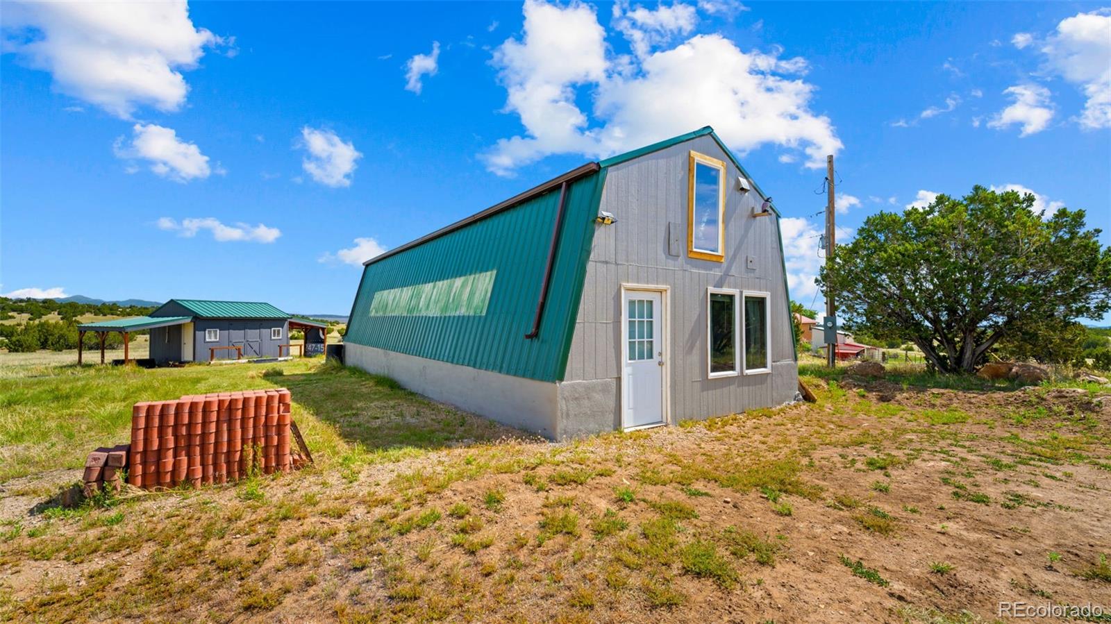 2904 Siloam Road Pueblo, CO 81005 - Photo 21 of 34 a front view of a house with a yard