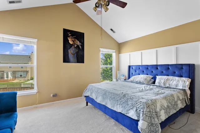 a bed sitting in a bedroom next to a window