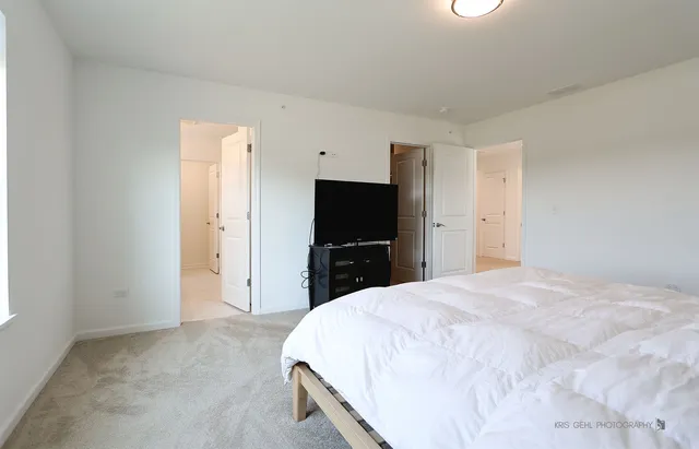 a bathroom with a double vanity sink mirror and shower