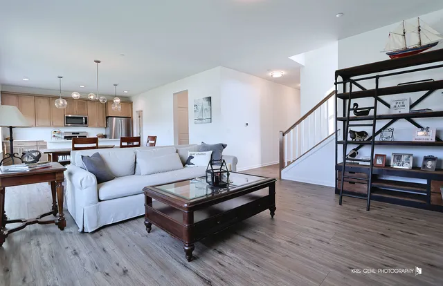 a kitchen with kitchen island a dining table and chairs