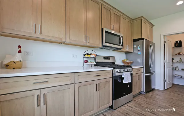 a kitchen with kitchen island granite countertop a sink cabinets and wooden floor