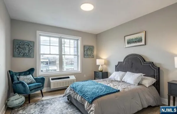 a bedroom with a bed and a couch