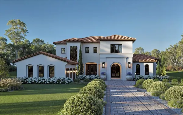 a front view of a house with a garden