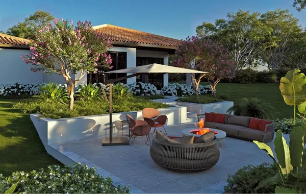 a view of a house with backyard sitting area and a garden