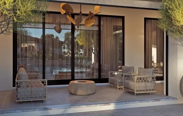 a living room with furniture and a glass door