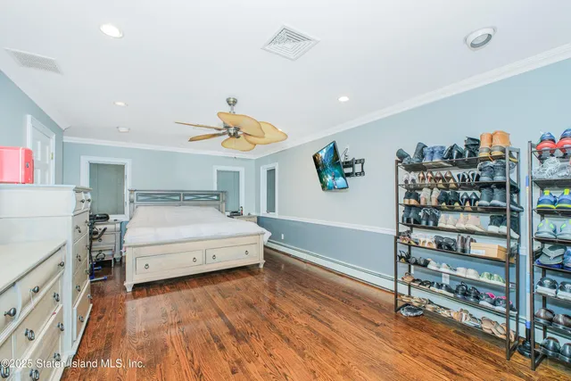 a bedroom with a bed and a book shelf