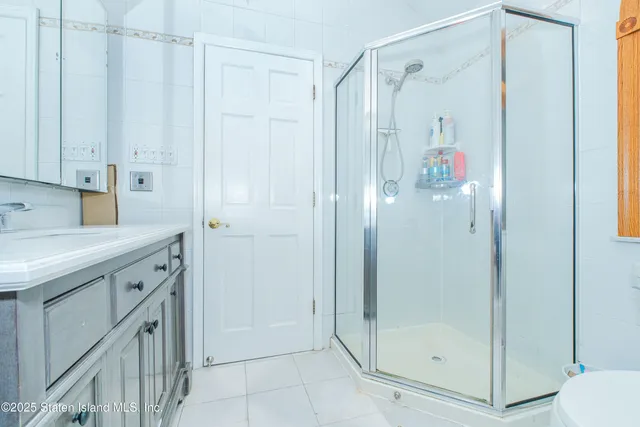 a bathroom with a shower and a sink