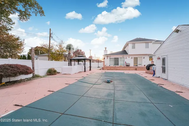 a view of a patio with a table and chairs