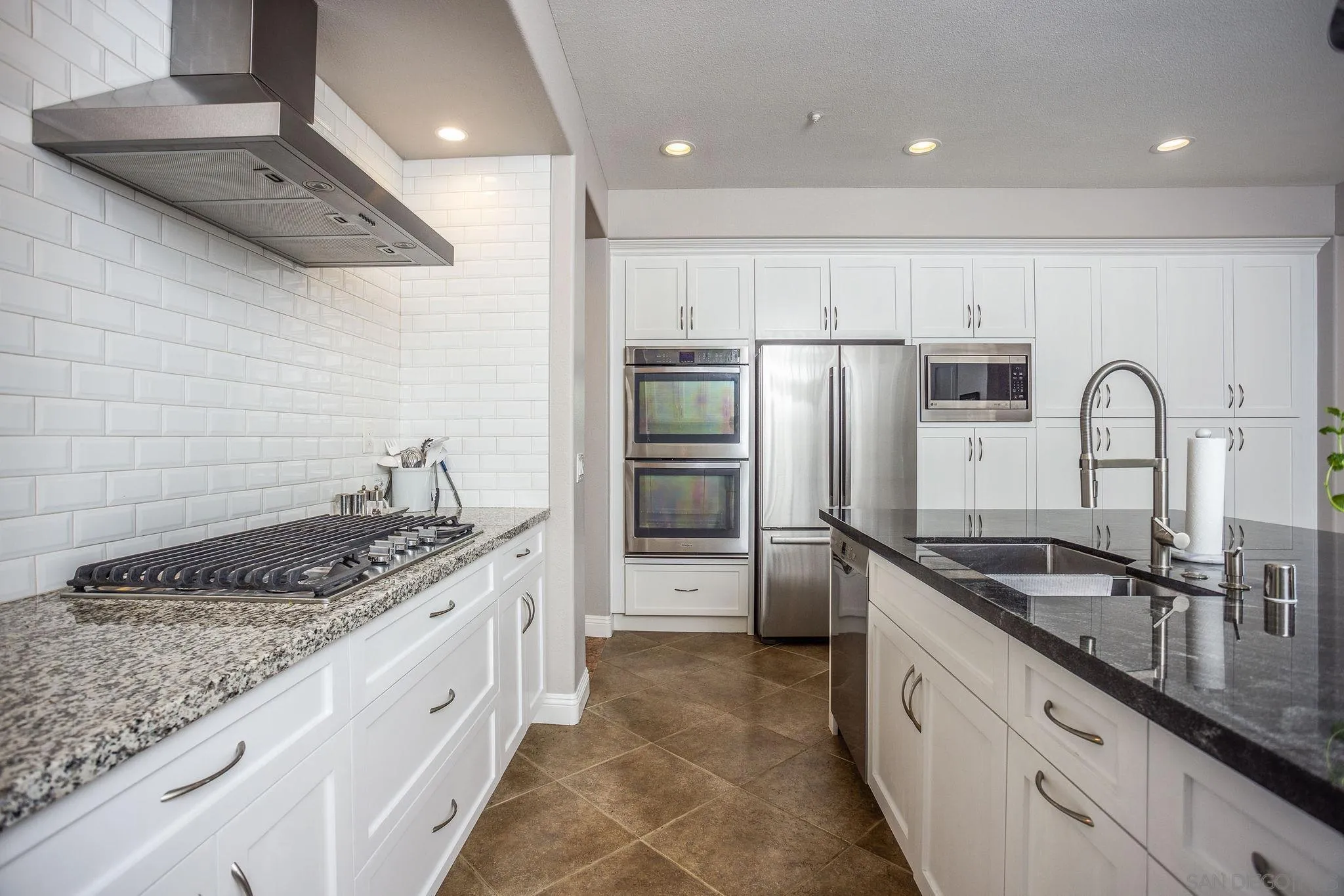 845 Vista Point Circle Vista, CA 92084 - Photo 13 of 58 a kitchen with stainless steel appliances granite countertop a sink stove and refrigerator