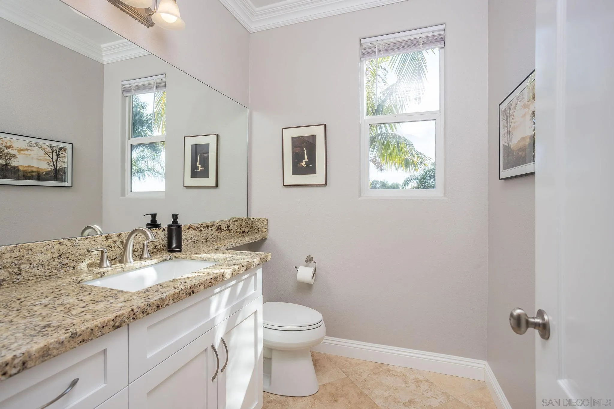 845 Vista Point Circle Vista, CA 92084 - Photo 16 of 58 a bathroom with a granite countertop toilet a sink and a window