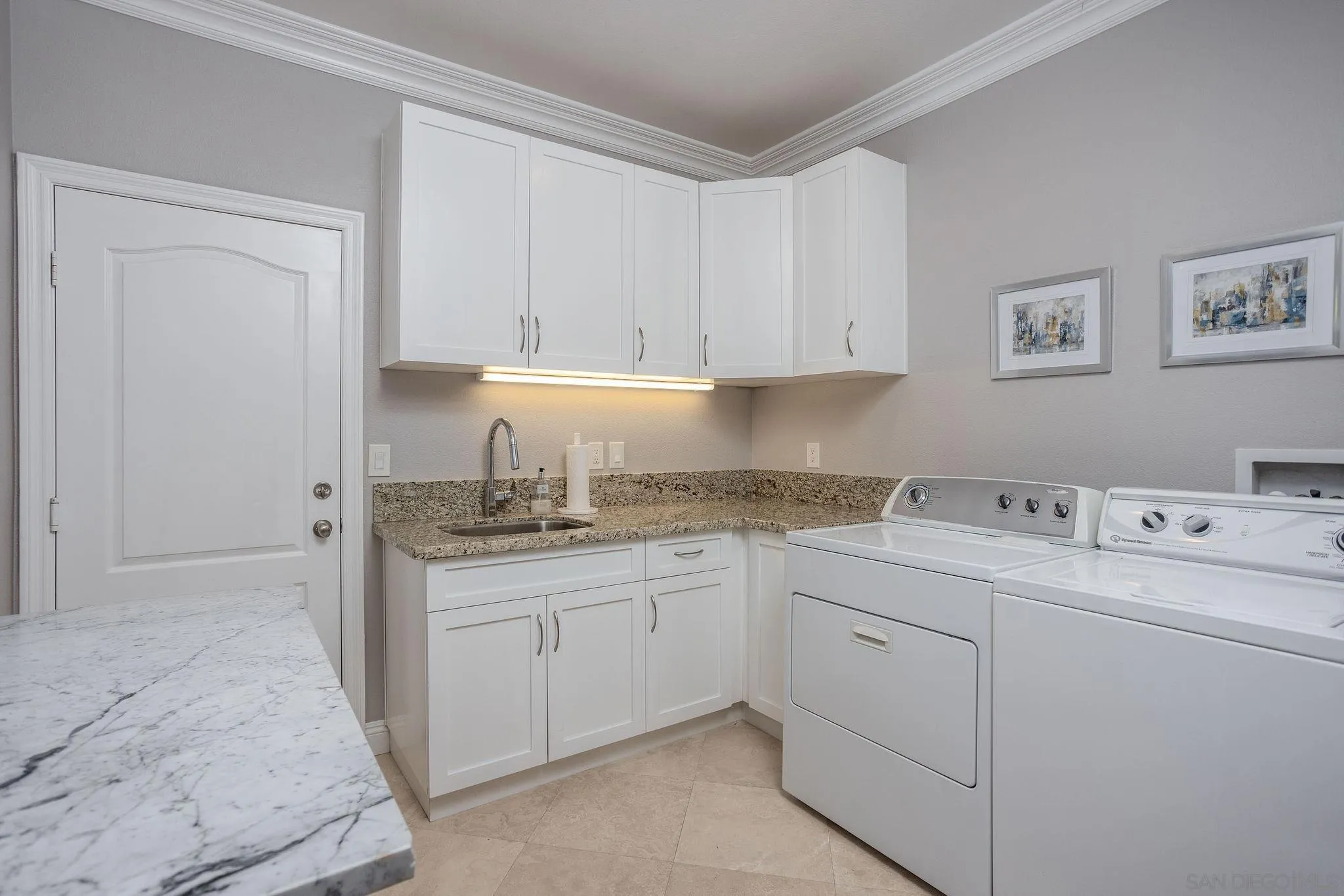 845 Vista Point Circle Vista, CA 92084 - Photo 17 of 58 a kitchen with a sink and cabinets