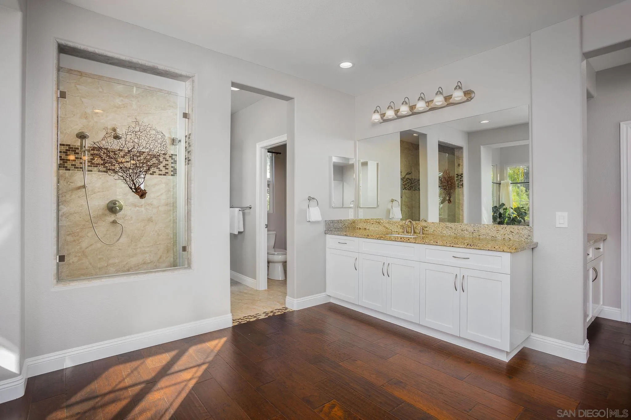 845 Vista Point Circle Vista, CA 92084 - Photo 24 of 58 a spacious bathroom with a double vanity sink and a mirror