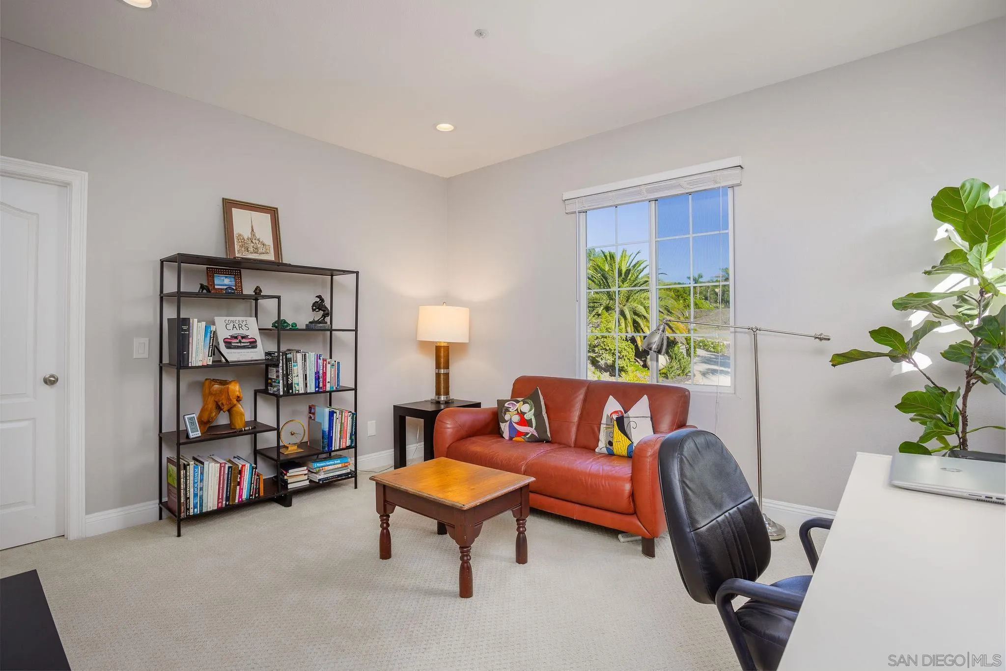 845 Vista Point Circle Vista, CA 92084 - Photo 33 of 58 a living room with furniture a bookshelf and a potted plant
