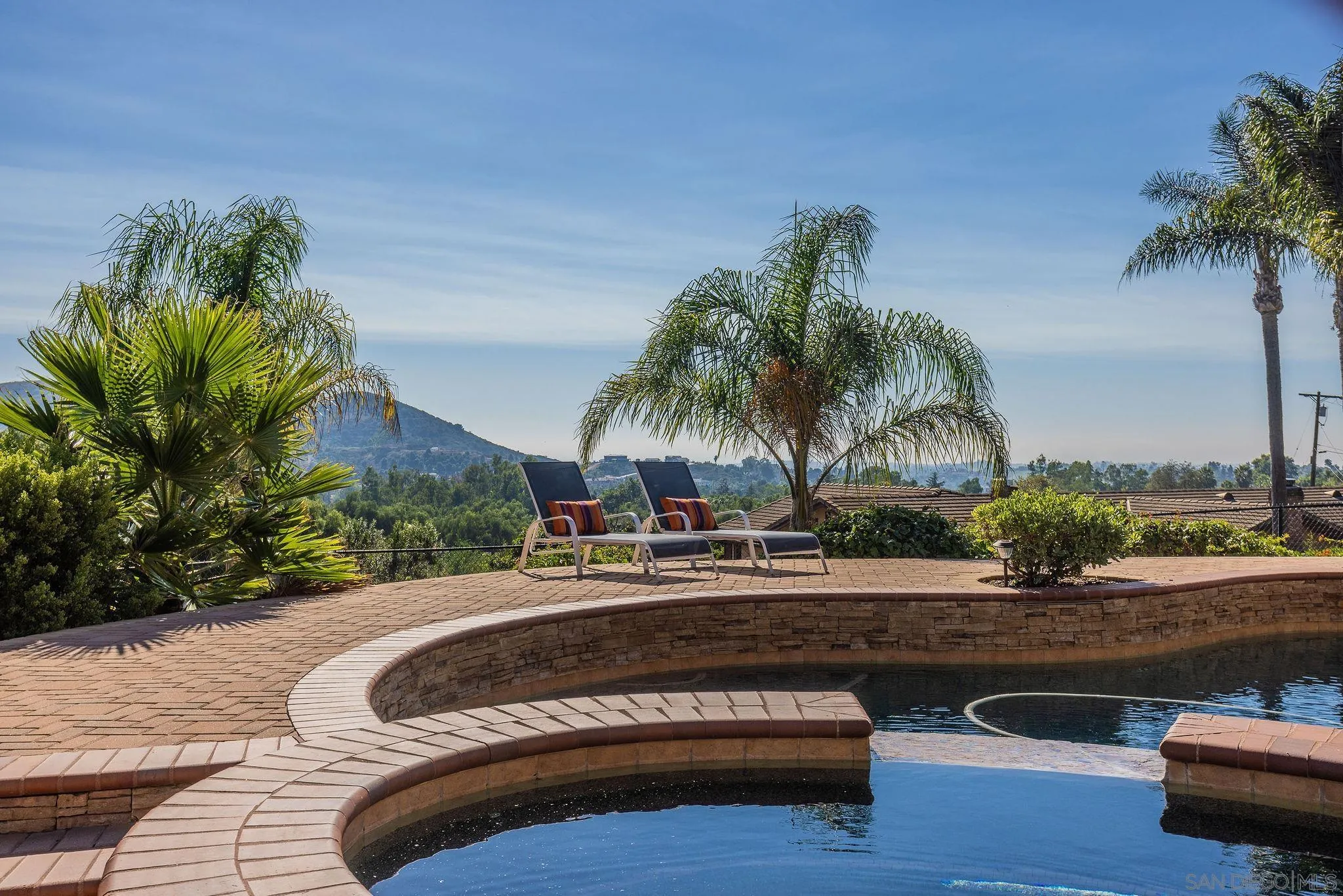 845 Vista Point Circle Vista, CA 92084 - Photo 39 of 58 a swimming pool with outdoor seating and palm trees