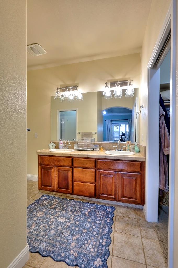 4152 Post Oak Drive Turlock, CA 95382 - Photo 54 of 71 a large bathroom with a sink and a large mirror