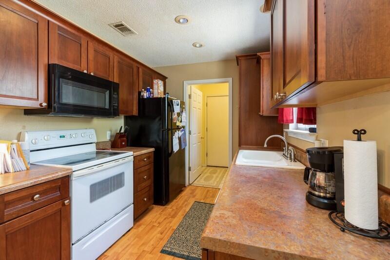 138 Edna Drive Crestview, FL 32536 - Photo 11 of 26 a kitchen with stainless steel appliances kitchen island granite countertop a refrigerator stove and sink