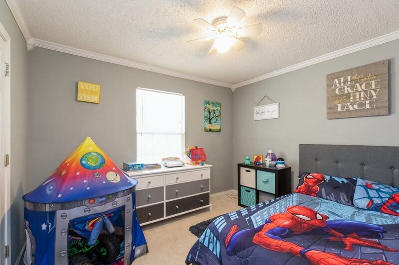 138 Edna Drive Crestview, FL 32536 - Photo 15 of 26 a bedroom with a bed and a workspace