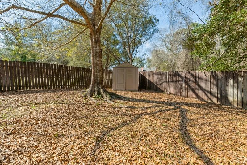 138 Edna Drive Crestview, FL 32536 - Photo 24 of 26 a backyard of a house with a bench