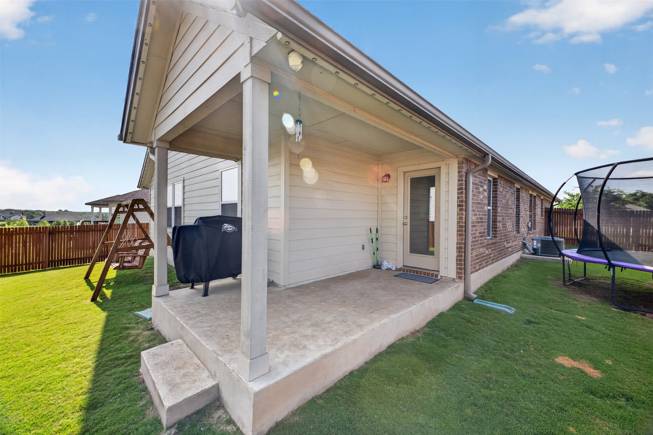 1009 Bright Star Cove Georgetown, TX 78628 - Photo 30 of 40 a view of an house with backyard porch and furniture
