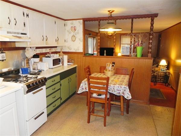 24 Wixon Road Dennis, MA 02639 - Photo 4 of 12 a kitchen with a table chairs stove and cabinets