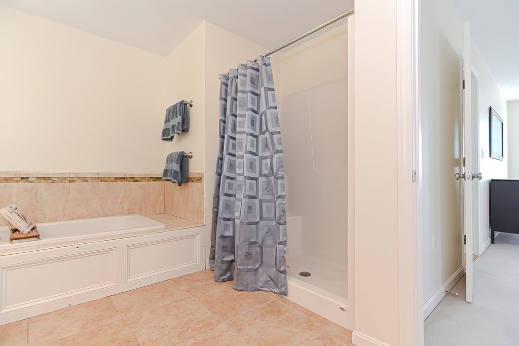 82 Swift Road Framingham, MA 01702 - Photo 27 of 39 a bathroom with a bathtub and a shower