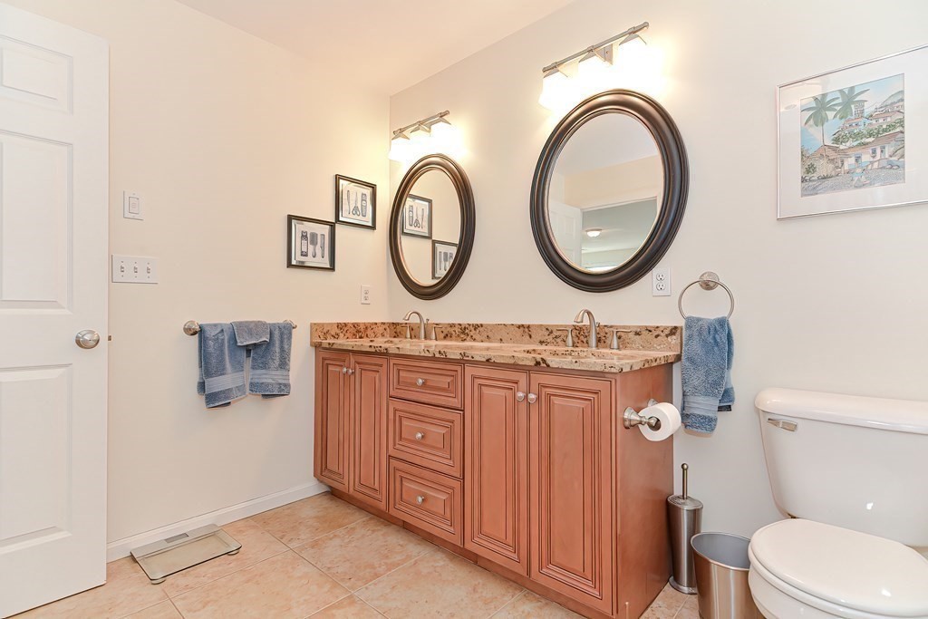 82 Swift Road Framingham, MA 01702 - Photo 28 of 39 a bathroom with a toilet a sink and a mirror