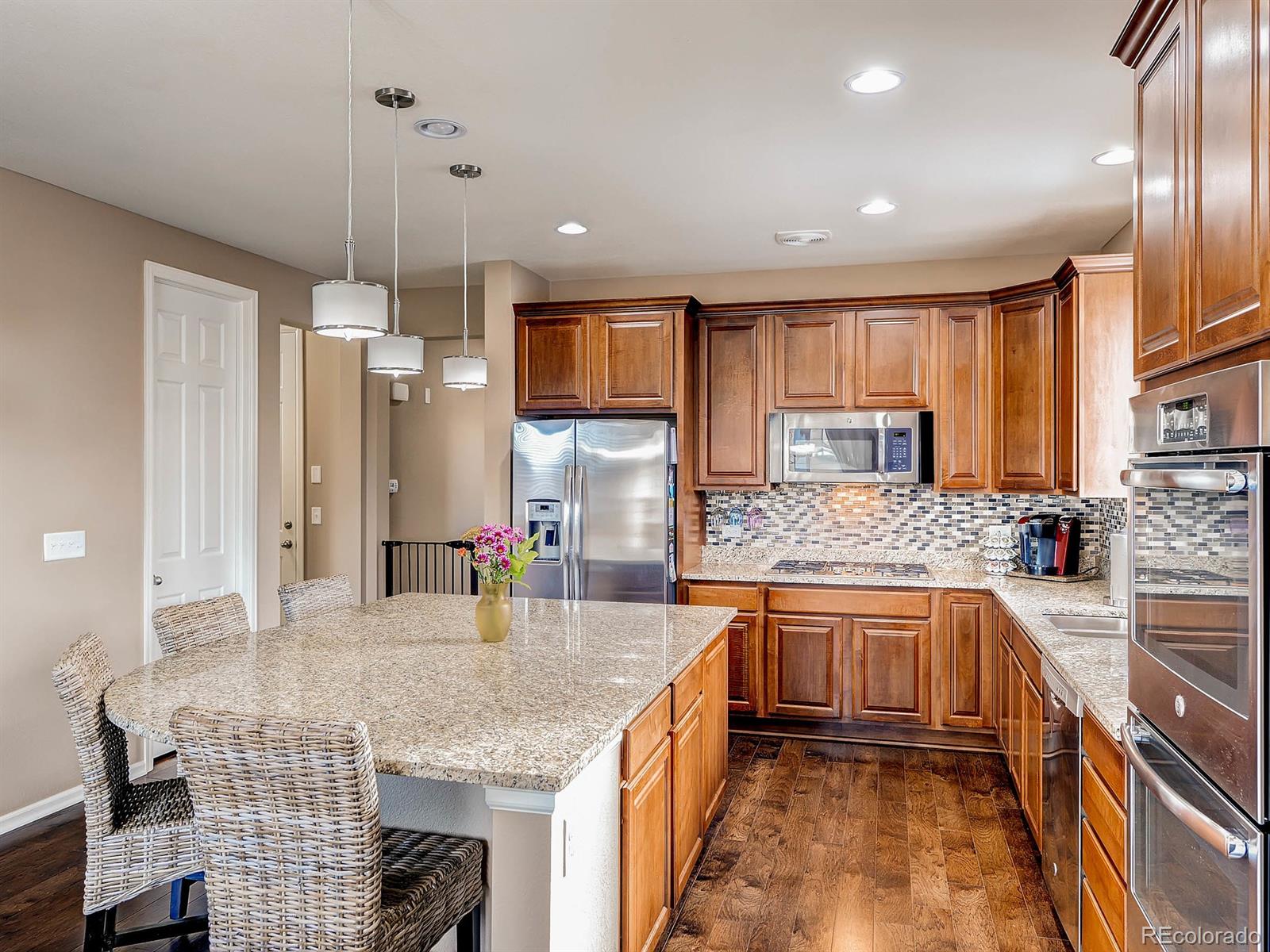 714 Springvale Road Castle Rock, CO 80104 - Photo 11 of 28 a kitchen with stainless steel appliances granite countertop a sink stove and refrigerator