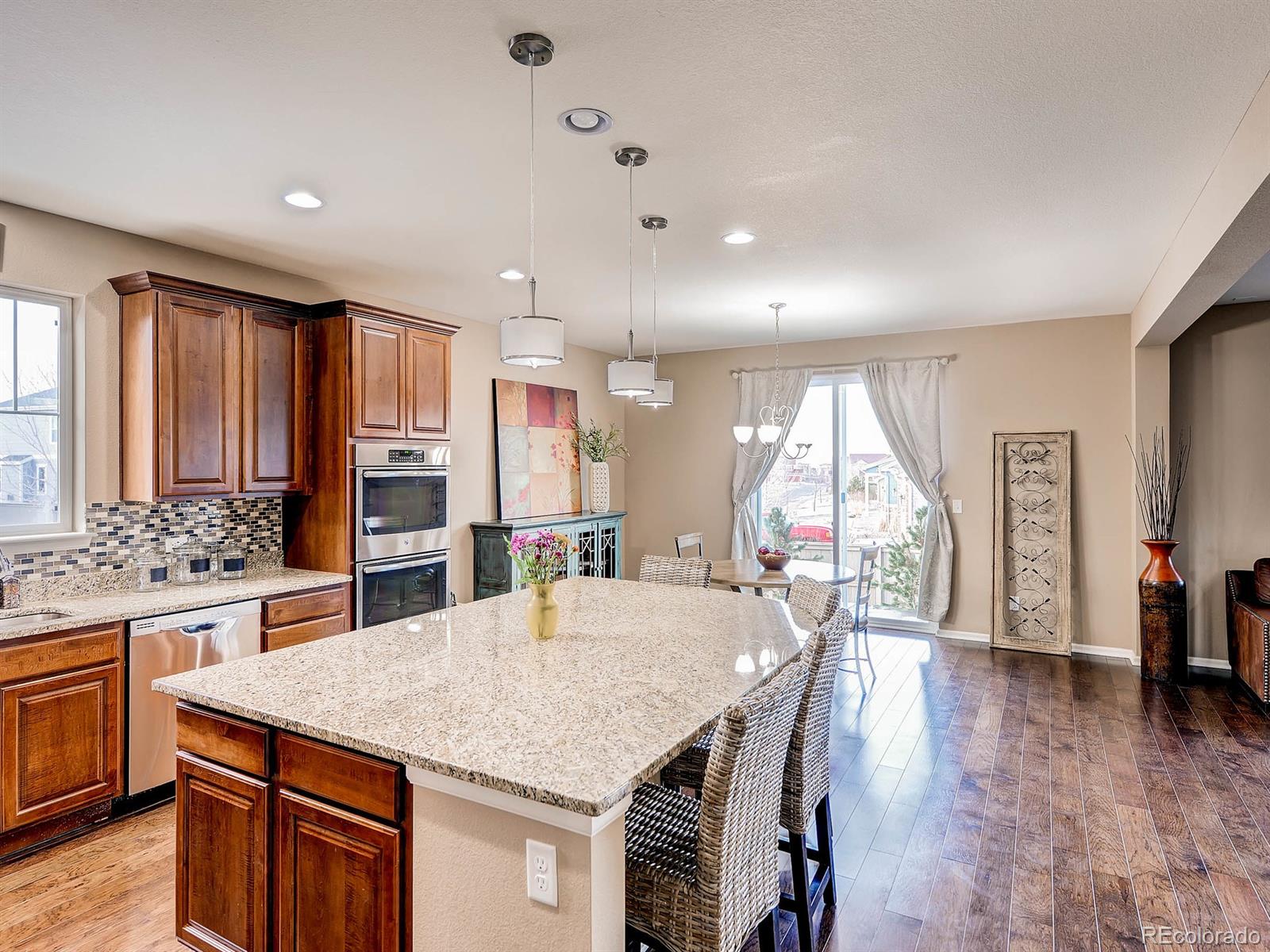 714 Springvale Road Castle Rock, CO 80104 - Photo 12 of 28 a kitchen with stainless steel appliances granite countertop a stove and a large window