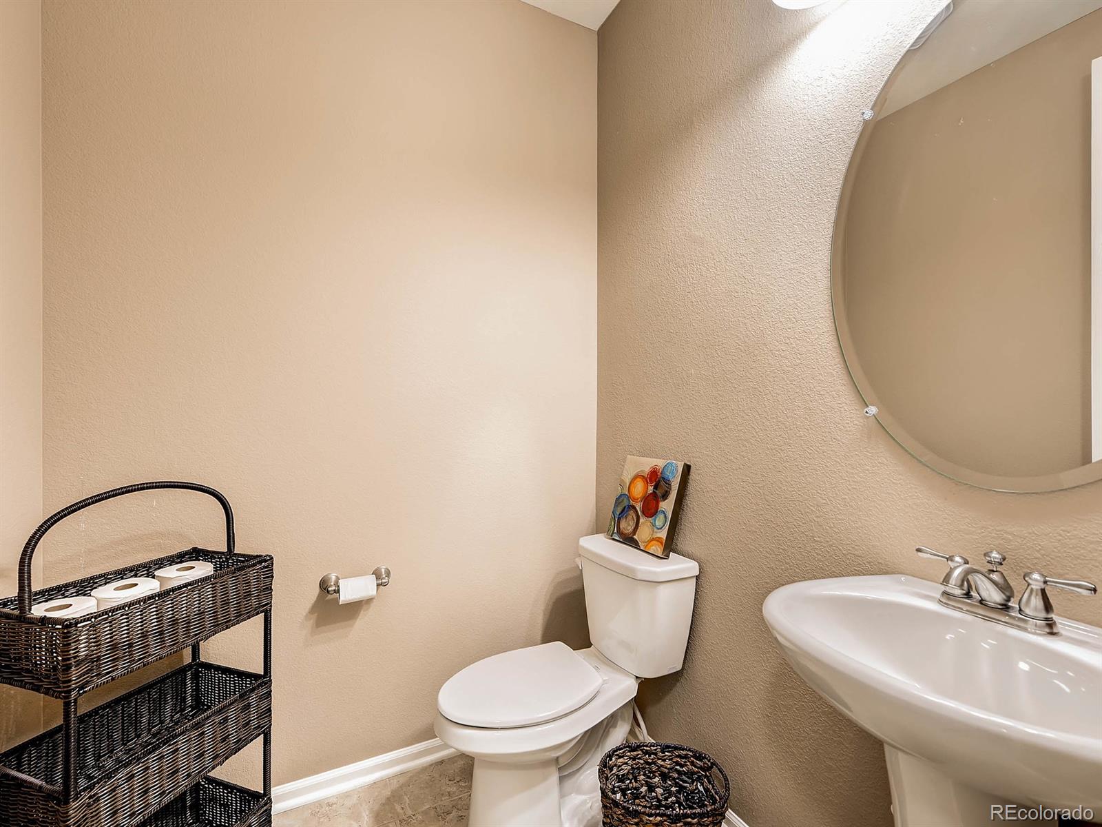 714 Springvale Road Castle Rock, CO 80104 - Photo 14 of 28 a bathroom with a sink a toilet and a mirror