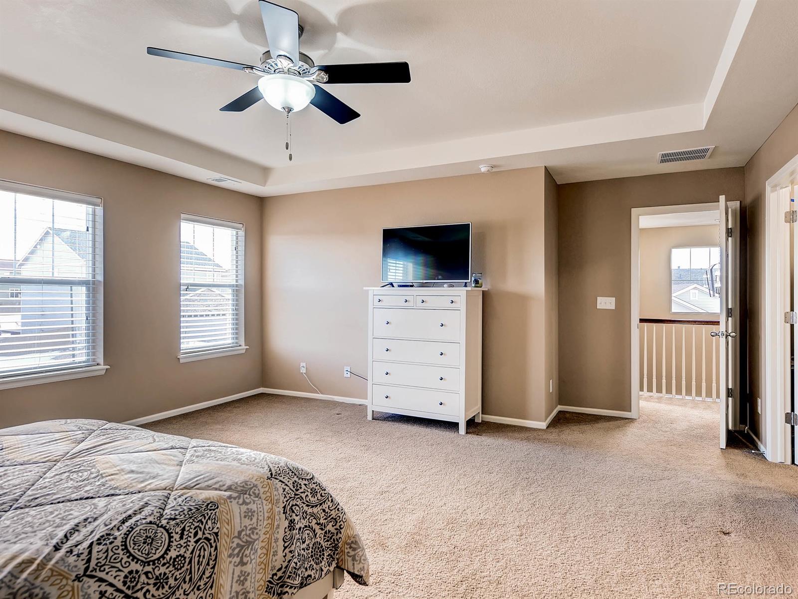 714 Springvale Road Castle Rock, CO 80104 - Photo 16 of 28 a spacious bedroom with a bed and a ceiling fan