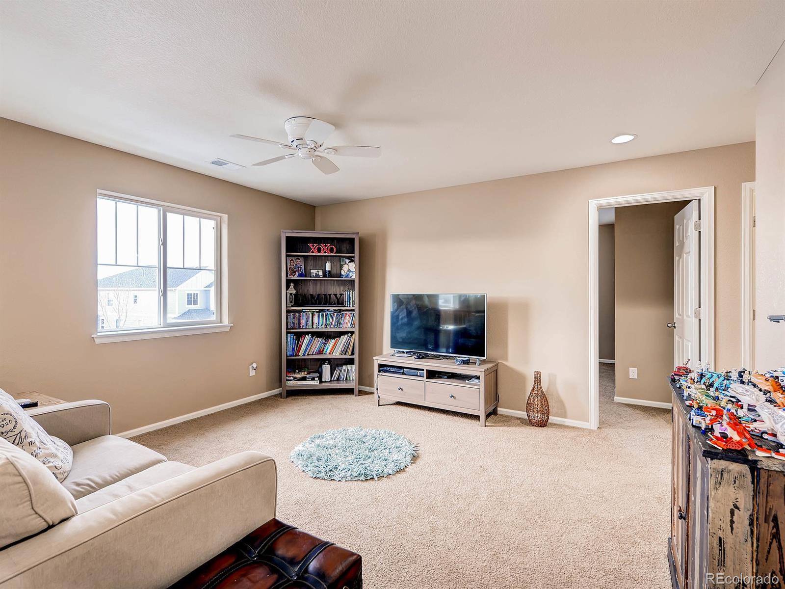 714 Springvale Road Castle Rock, CO 80104 - Photo 22 of 28 a living room with furniture and a flat screen tv