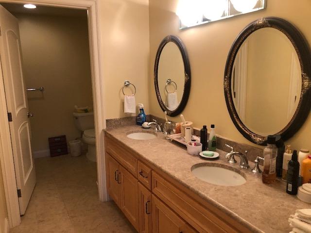 10 Crystal Springs Road, Unit 1509 San Mateo, CA 94402 - Photo 10 of 24 a bathroom with a granite countertop sink and a mirror