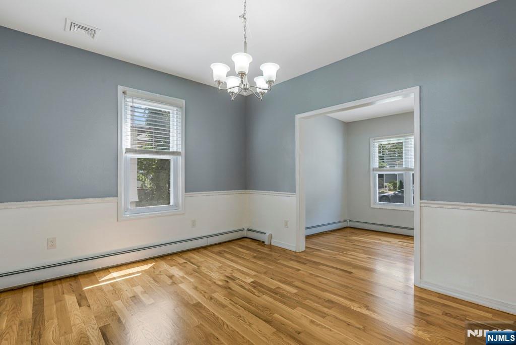 24 Sunderland Avenue Rutherford, NJ 07070 - Photo 11 of 40 a view of an empty room with wooden floor and a window