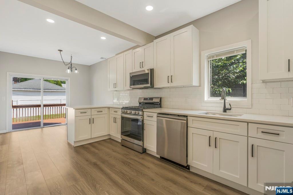 24 Sunderland Avenue Rutherford, NJ 07070 - Photo 13 of 40 a kitchen with sink cabinets and wooden floor