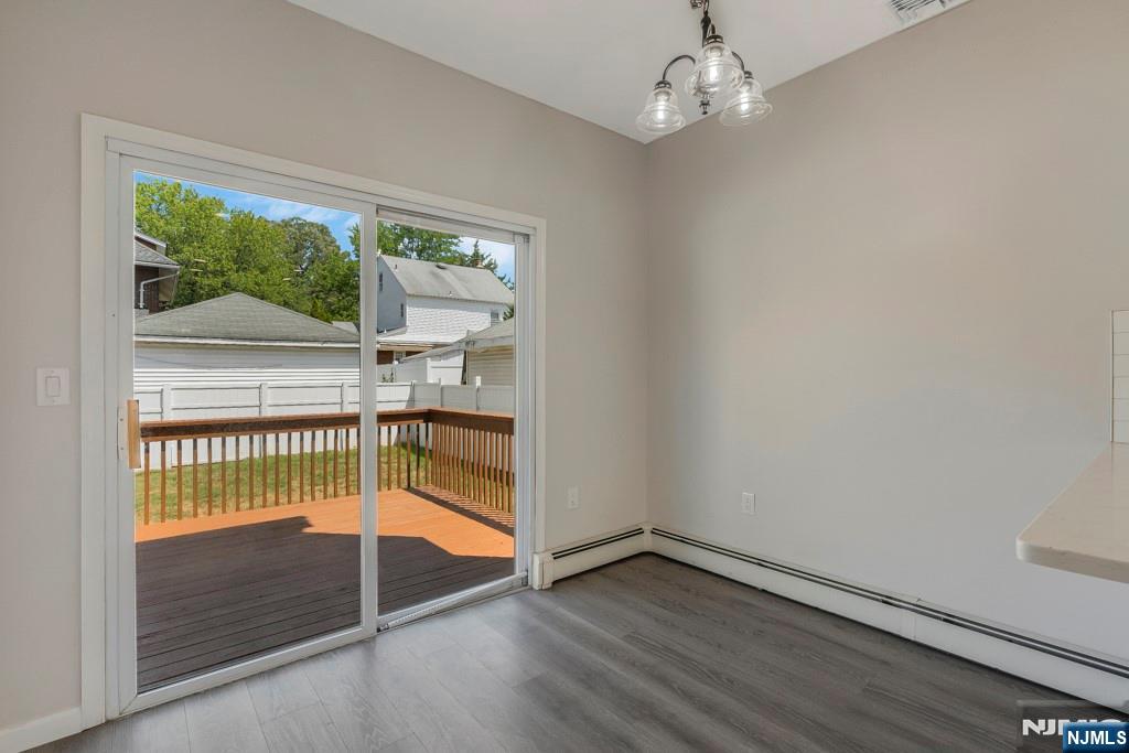 24 Sunderland Avenue Rutherford, NJ 07070 - Photo 15 of 40 an empty room with wooden floor fan and windows