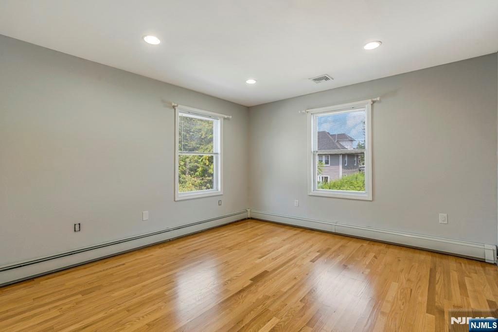 24 Sunderland Avenue Rutherford, NJ 07070 - Photo 17 of 40 wooden floor in an empty room with a window