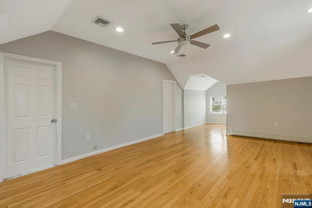 24 Sunderland Avenue Rutherford, NJ 07070 - Photo 21 of 40 a view of an empty room with wooden floor and a ceiling fan